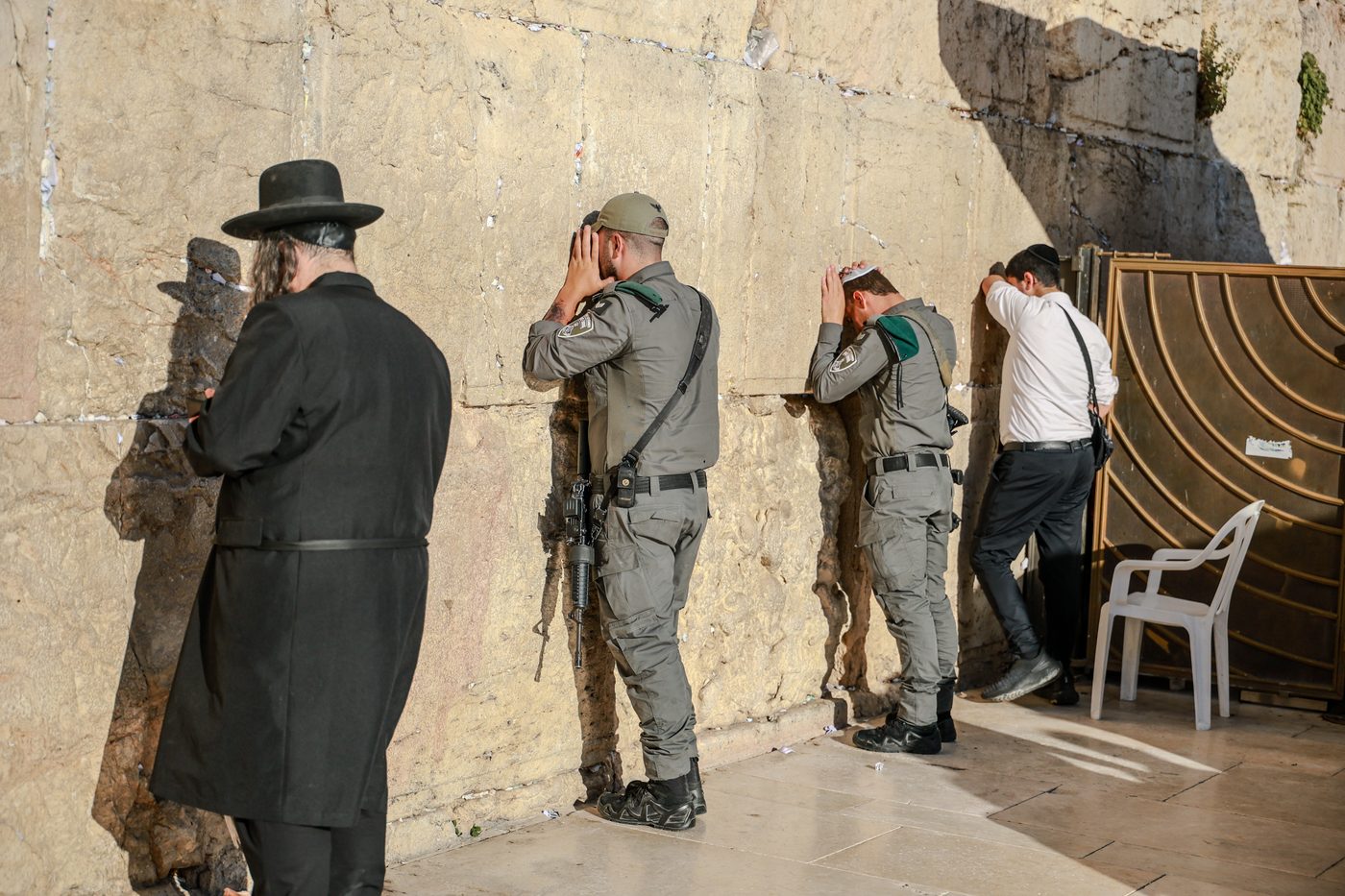 Soldiers and civilians at prayer at the Western Wall in Jerusalem.